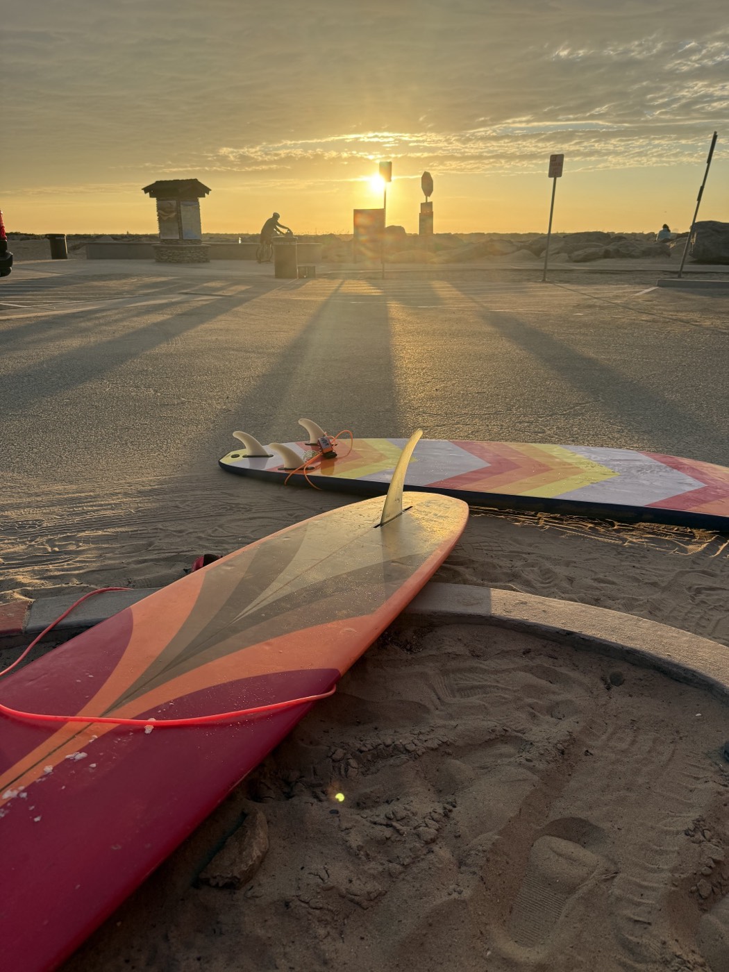 Two retro surfboards on the sand at golden hour